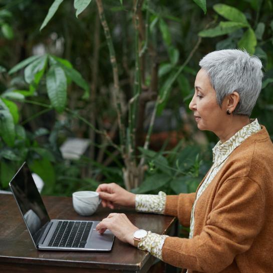 woman sitting in garden at the computer